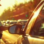A police officer stands beside a car, illustrating your rights when being pulled over by law enforcement.